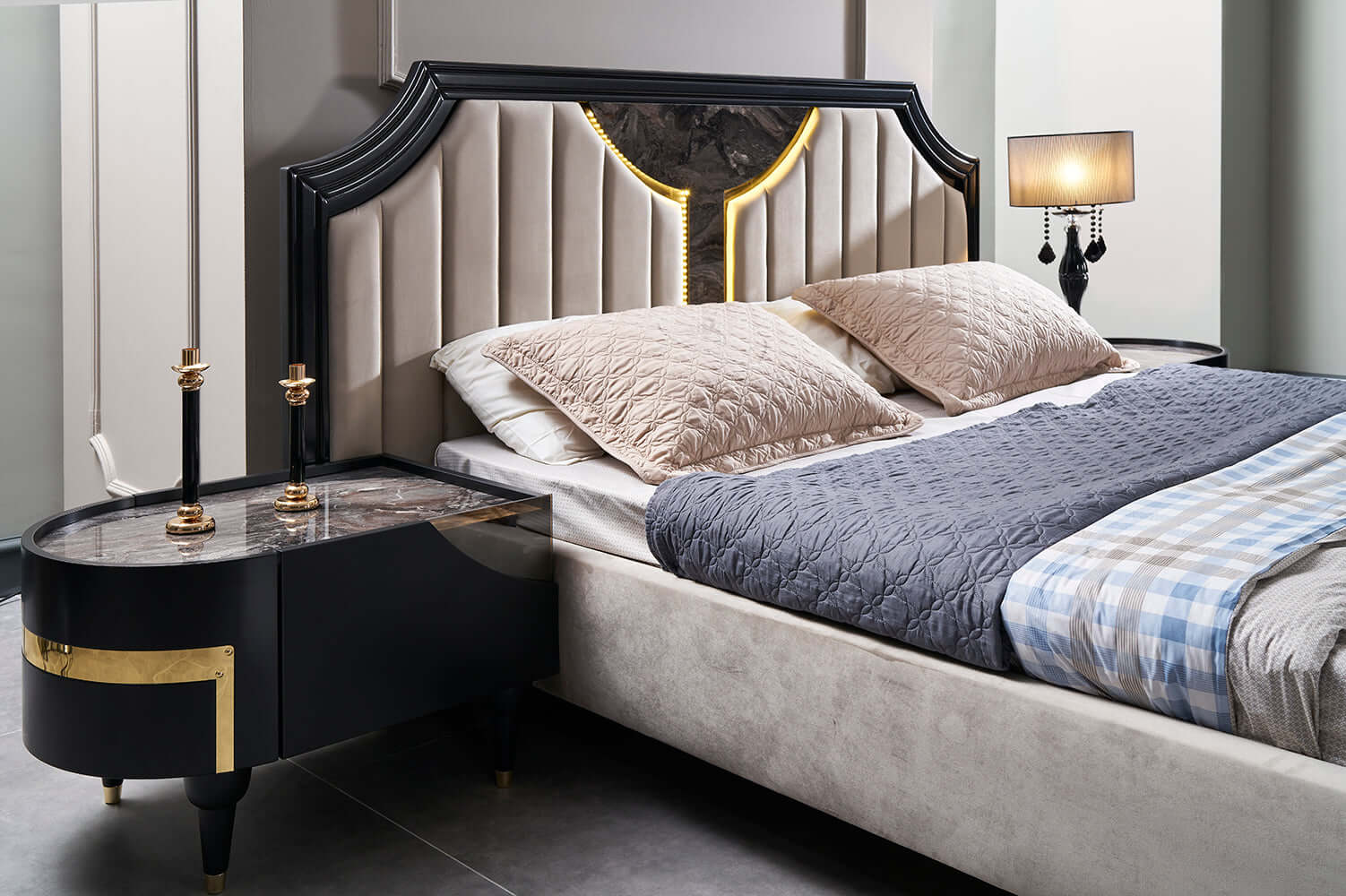 alt= Modern bedroom with a large bed, stylish dark wardrobe, vanity table with mirror, and elegant gray and beige decor.